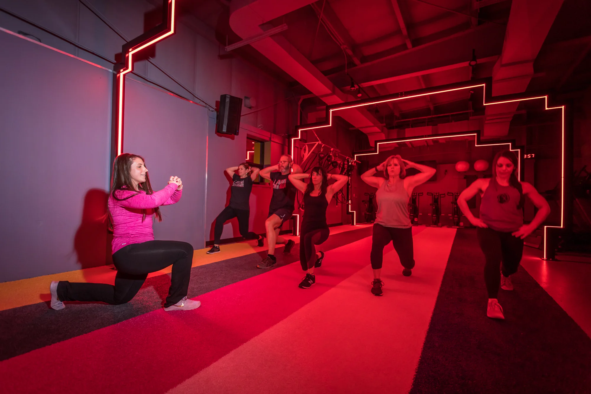 Members practising lunges together in Stronger’s training studio.
